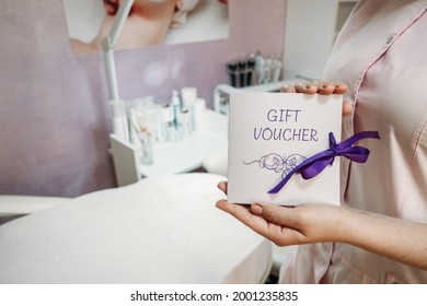 Beauty Salon Gift Certificate. Salon Gift Vouchers. Cosmetology Gift Card In Female Cosmetologist Hands On Beauty Spa Salon Background