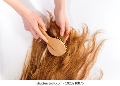 Beauty salon. Hair stylist at work. Cares about a healthy and clean hair. Woman's hand brushing blonde hair. - Shutterstock ID 1023218875