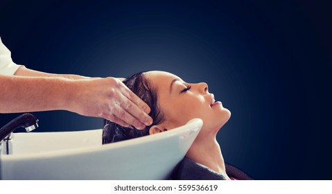 Beauty Salon And People Concept - Happy Young Woman And Hairdresser Hands Washing Head And Hair Over Blank Black Background