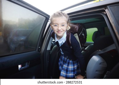 Beauty School Aged Kid Girl In Glasses And Uniform Near The Car