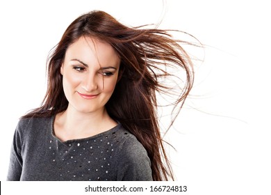 Beauty shot of a beautiful, long haired, brunette woman with her hair fluttering.