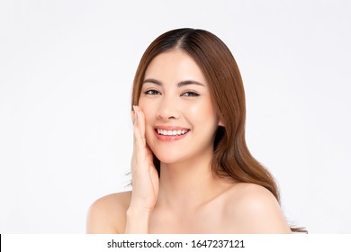 Beauty Shot Of Smiling Asian Woman Model With Clear Fair Skin Doing Hand Touching Face Pose In White Isolated Background For Skincare Concept