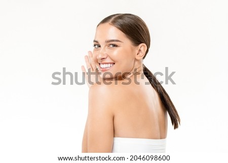 Beauty shot of smiling pretty Caucasian woman with clear and healhy skin in isolated white studio background