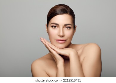 Beauty And Skin Care Concept. Beautiful Natural Woman With Clean Healthy Luminous Skin. Beauty Portrait On Grey Background With Copyspace