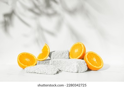 Beauty skin care product presentation podium and display made with porous stones and oranges on white sunny background. Studio photography. - Shutterstock ID 2280342725