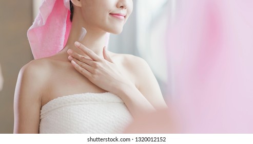 Beauty Skin Care Woman Look To Mirror And Apply Neck Cream After Shower