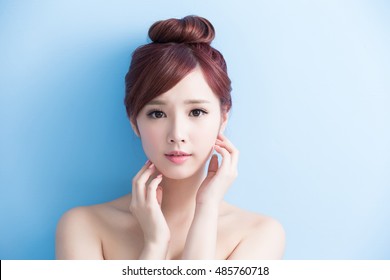 beauty  skin care woman smile to you isolated on bluebackground, asian