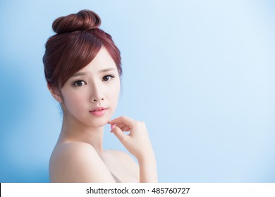 beauty  skin care woman smile to you isolated on bluebackground, asian