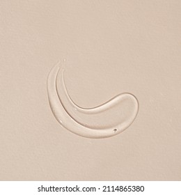 Beauty, Skincare Product Setting. Transparent Cosmetic Gel Smear On Neutral Beige Background. Flat Lay, Top View