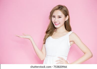 beauty skincare woman show something to you on the pink background