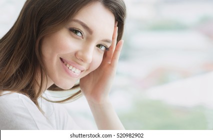 Beauty smiling model with natural make up and long eyelashes. Youth and  skin care concept. Spa and wellness. Make up, long hair and lashes. Close up, selective focus. - Shutterstock ID 520982902