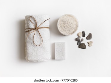 Beauty And Spa Concept. Towel, Sea Salt, Pumice And Stones On White Paper Background. Flat Lay.