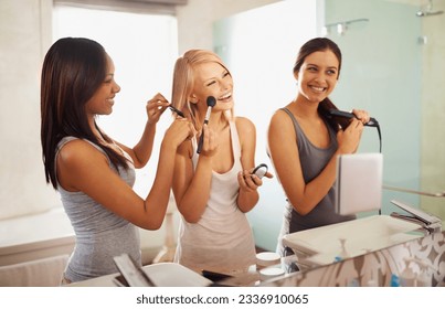 At the beauty station. Shot of three friends applying makeup in front of the mirror. - Powered by Shutterstock