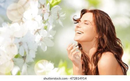 Beauty, Summer, Emotion, Expression And People Concept - Happy Beautiful Woman Over Natural Spring Cherry Blossom Background