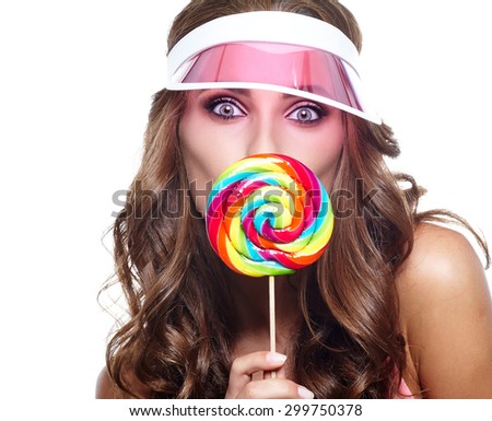Beauty summer model girl Eating colourful lollipop. 