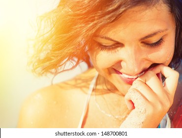 Beauty Sunshine Girl Portrait. Happy Woman Smiling And Looking Down. Sunny Summer Day Under The Hot Sun On The Beach. 