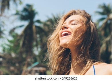 Beauty Sunshine Girl Portrait. Pretty Happy Woman Enjoying Summer Outdoors. Sunny Summer Day Under The Hot Sun On The Beach.