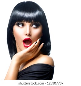 Beauty Surprised Brunette Woman isolated on White background. Beautiful Girl opening Mouth. Emotion. Red Lips and Black Nails. Hairstyle. Makeup