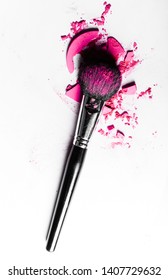 Beauty texture, cosmetic product and art of make-up concept - Brush with crushed eyeshadow and powder close-up isolated on white background