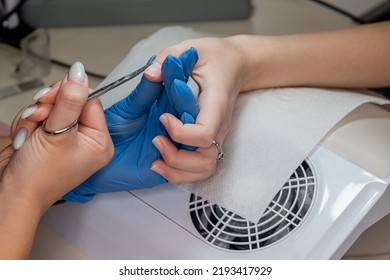 Beauty Therapist Doing Manicure On Hand Of Young Asian Woman In Spa Salon. Manicure Process In Beauty Salon. Hands Of Manicure Master And Client Top View. Master Of Nail Service.