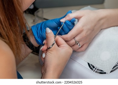 Beauty Therapist Doing Manicure On Hand Of Young Asian Woman In Spa Salon. Manicure Process In Beauty Salon. Hands Of Manicure Master And Client Top View. Professional Master