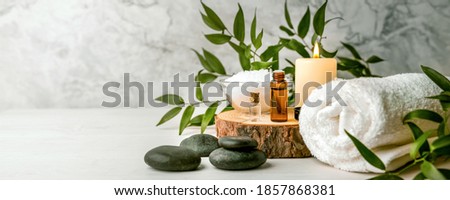 beauty treatment items for spa procedures on white wooden table. massage stones, essential oils and sea salt. copy space Zdjęcia stock © 