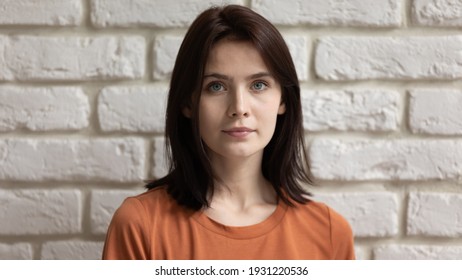 Beauty Wearing Casual. Profile Picture Of Calm Pretty Millennial Lady Against White Stone Wall. Headshot Portrait Of Young Teenage Female With Dark Straight Hair Beautiful Face With Healthy Clear Skin