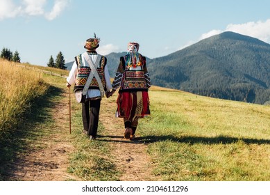 Beauty Wedding Couple In Traditional Clothes Over Mountains Background. Ukrainian Folklore Wedding, Culture, Ethical Traditions, Concept.