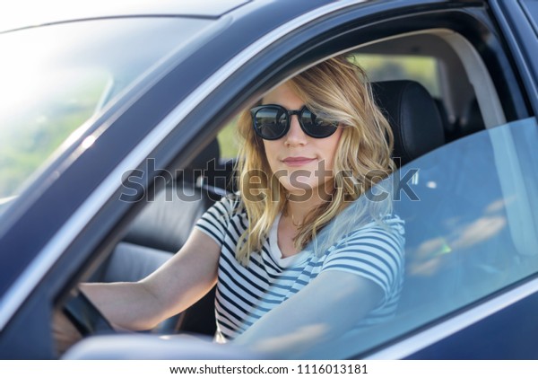 Beauty at the wheel of the car. Attractive blonde in\
the car.