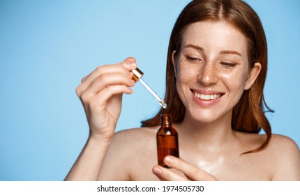 Beauty. Woman With Bottle Of Essential Oil For Glowing And Hydrated Face Skin. Facial Treatment With Serum Collagen, Hyaluronic Acid And Natural Vitamin E For Anti-Aging Therapy