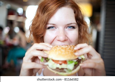 Beauty Woman In Cafe Eating Hamburger