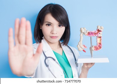 Beauty Woman Doctor Show Stop To You With Colorectal Cancer Concept On The Blue Background