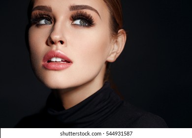 Beauty Woman Face. Closeup Of Beautiful Young Female Model With Soft Smooth Skin And Professional Facial Makeup. Portrait Of Sexy Girl With Long Fake Eyelashes And Perfect Make-up. High Resolution