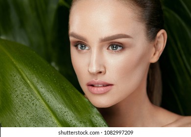 Beauty Woman Face With Healthy Skin And Green Plant