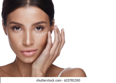 Beauty Woman Face With Makeup. Portrait Of Beautiful Female Touching Soft Smooth Facial Skin With Hands. Closeup Of Sexy Girl With Fresh Make-up And Concealer, Corrector Under Eyes. High Resolution