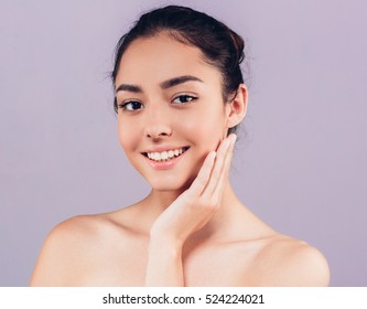 Beauty Woman face Portrait. Beautiful Spa model Girl with Perfect Fresh Clean Skin. Brunette female looking at camera and smiling. Youth and Skin Care Concept. - Shutterstock ID 524224021