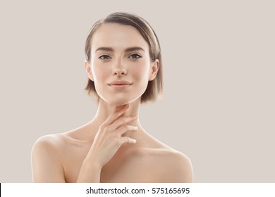 Beauty Woman face Portrait. Beautiful model Girl with Perfect Fresh Clean Skin color lips purple red. Blonde brunette short hair Youth and Skin Care Concept. Isolated on beige background - Shutterstock ID 575165695