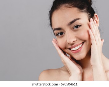 Beauty Woman face Portrait. Beautiful model Girl with Perfect Fresh Clean Skin tanned. Healthy teeth smile Youth and Skin Care Concept. - Shutterstock ID 698504611