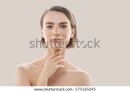 Beauty Woman face Portrait. Beautiful model Girl with Perfect Fresh Clean Skin color lips purple red. Blonde brunette short hair Youth and Skin Care Concept. Isolated on beige background