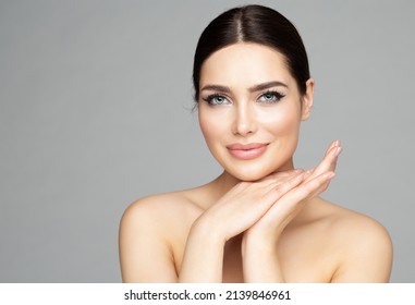Beauty Woman Face Skin Care. Beautiful Woman Portrait with Full Lips and Long Eyelashes over Gray. Hands Manicure and Facial Treatment Cosmetics. Spa Massage and Face Lift Cosmetology
