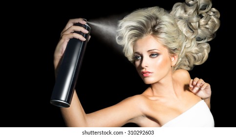 Beauty Woman Fixes Her Hair With A Hairspray