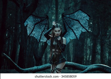 Beauty Woman ghost vampire dragon demon bat wings, succubus in night forest, crazy girl walking in fashion leather black latex sexy outfit. Creative design. Fantasy dark queen. Holiday party Halloween
