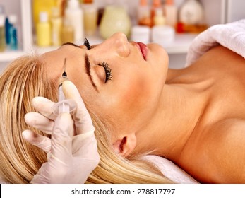 Beauty Woman Giving Botox Injections On Forehead.