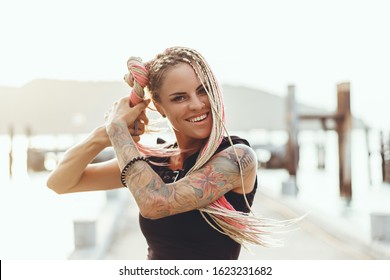 Beauty woman hair dreadlocks posing in the beach on mask, cyber style, USA, burning man, festival, sunglasses, tan skin, tattoo, black color, California, Nevada, desert. USA, brutal, astral, music