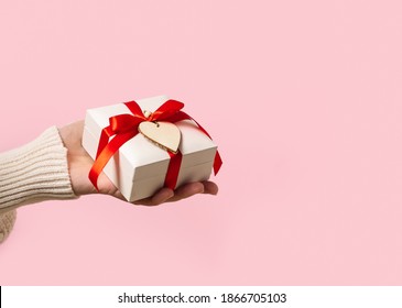 Beauty Woman hands holding Gift box with red bow and heart on pink background, close-up. pastel colors, copy space for text. Valentine gift. Banner for Christmas, hew year, birthday concept. - Shutterstock ID 1866705103