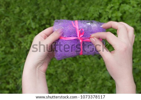 Beauty Woman hands holding Gift box with  bow over, close-up.