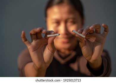 Beauty woman happy to breaking a cigarette. International Wold tobacco day and  quit smoking cigarettes concept. - Shutterstock ID 1925013713