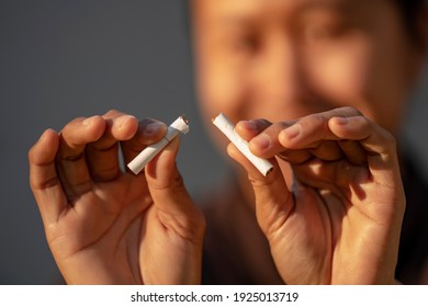 Beauty woman happy to breaking a cigarette. International Wold tobacco day and  quit smoking cigarettes concept.