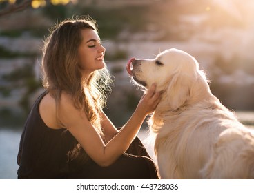 Beauty woman with her dog playing outdoors - Shutterstock ID 443728036