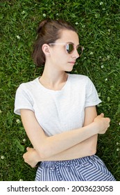 Beauty Woman Laying On The Back On The Grass Overhead View